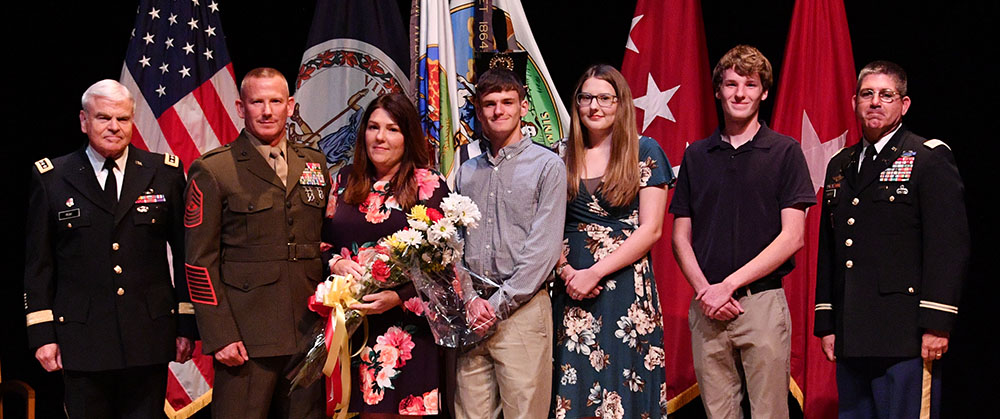 Sgt. Maj. Sowers pauses on stage with his family.