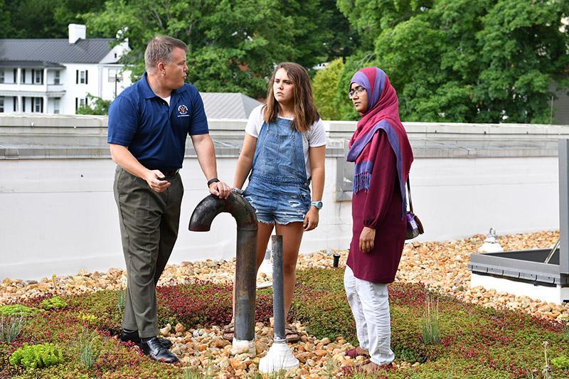 Maj. Paul Ackerman ’93 explains the watering system on the CPTF green roof to Maria Vargas ’22 and Dr. Tanjina Afrin.—VMI Photo by Kelly Nye.