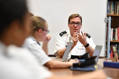 Col. Howard Sanborn sits with cadets in Scott Shipp Hall.