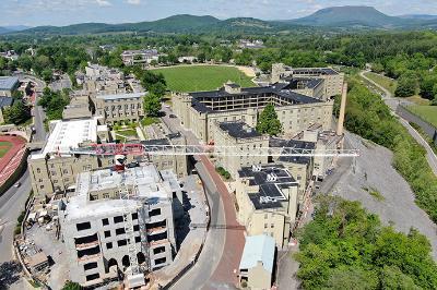 A large crane is shown in front of construction to Scott Shipp Hall