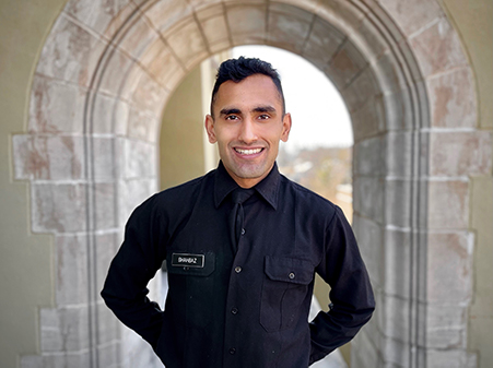 Cadet Jahanzib Shahbaz ’21 standing under arch on Post