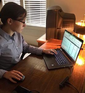 Josie Freeman '23 works on her laptop computer