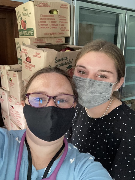 Erin Kozlowski '22 poses for a photo with Christina Creech, food bank supervisor at STOP Inc.—Photo courtesy of Erin Kozlowski '22.