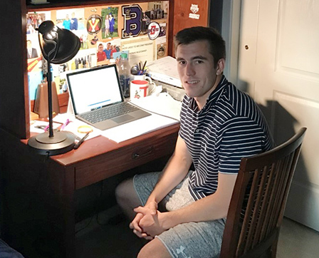 Thomas Muldowney '21 is shown in front of his laptop computer.