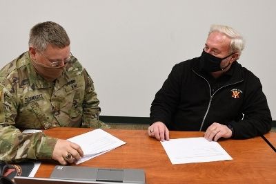 Larry Camper meets with a member of VMI staff