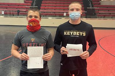 Luke Fegley ’24 and Freddy Junko ’24 participate in the holiday community outreach project by writing letters to seniors in local facilities. – Photo courtesy of Jim Gibson, VMI head wrestling coach.
