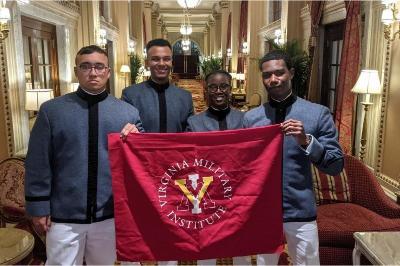 Fatoumata Diallo ’23, Wesley Barbara ’23, Joshua Kent ’24, and Kyle Bordeaux ’22 pose with VMI flag.—Photo provided by E. Sean Lanier ’94.