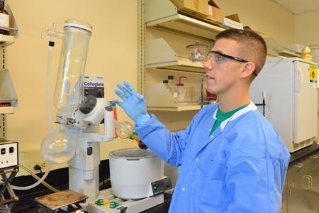 Owen Ahrens ’24 conducts research on the synthesis and reactivity of cobalt-centered molecules in the lab at VMI.—VMI Photo by Marianne Hause.