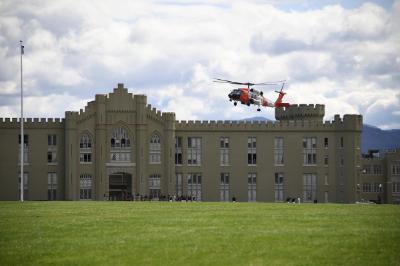U.S. Coast Guard HH-60 helicopter flies above post