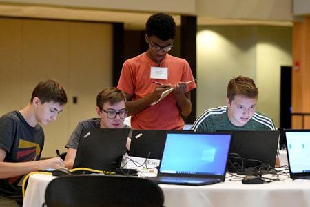 Goldie Richardson, senior at Parry McCluer High School, shares clues with her team during the second annual CyberSmart Workshop held June 6-10 at VMI. -VMI Photo by Kelly Nye.