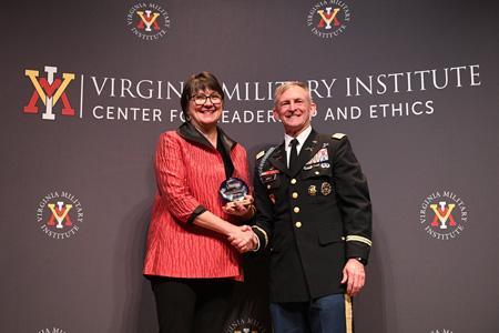 Bettina Ring accepts the 2022 Captain Ron Erchul Environmental Leadership Award from Col. Dave Gray, director for the VMI Center for Leadership and Ethics on March 31 in Marshall Hall.—VMI Photo by H. Lockwood McLaughlin.