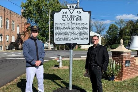 Mitchell Masterson '21 and his mentor, Maj. Jochen S. Arndt pose in front of Ota Benga historic sign marking where he died.