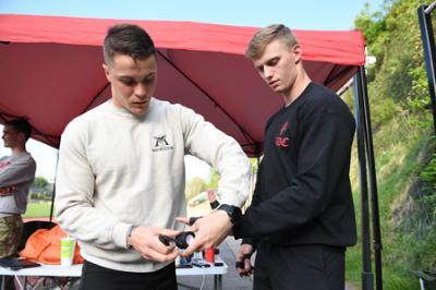 Richard Stacpoole ’22 wraps Matthew Ehret’s hands with tape for protection.