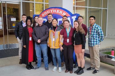 Photo of VMI cadets posing in front of conference at the 2021 SoCon Undergraduate Research Forum (SURF).