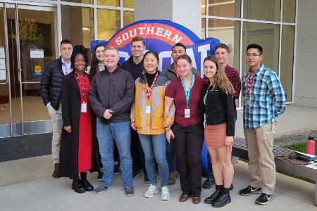 Photo of VMI cadets posing in front of conference at the 2021 SoCon Undergraduate Research Forum (SURF).