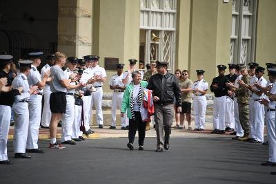 Vergie Moore is led through applauding crowd by Commandant Col. Bogart