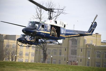 Air Force helicopter landing on the parade ground to take cadets in Air Force ROTC for a ride.