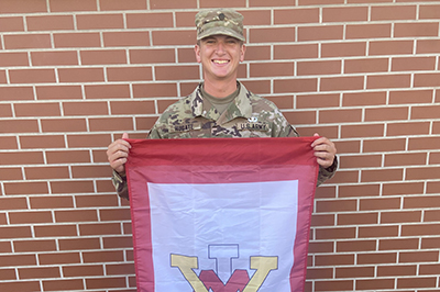 Cadet Carter Hugate '24 holds VMI flag at Army Airborne School