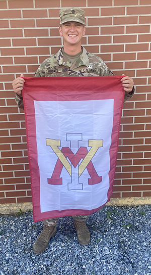 Cadet Carter Hugate '24 holds VMI flag at Army Airborne School