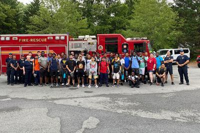 Students and members of Lexington Fire Department pose with a fire truck.
