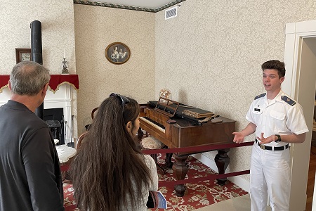 Student at VMI interacts with museum visitors during tour.