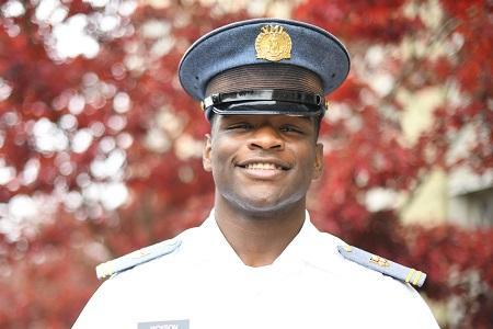 Brian Jackson ’24 in military school uniform in front of autumn leaves