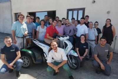Study abroad students - cadets from VMI - pose with prototype electric vehicle in Italy.