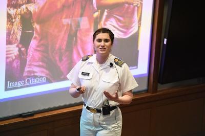 Gabriella Handford ’24, an honors student at VMI, stands in front of a screen showing her research thesis.