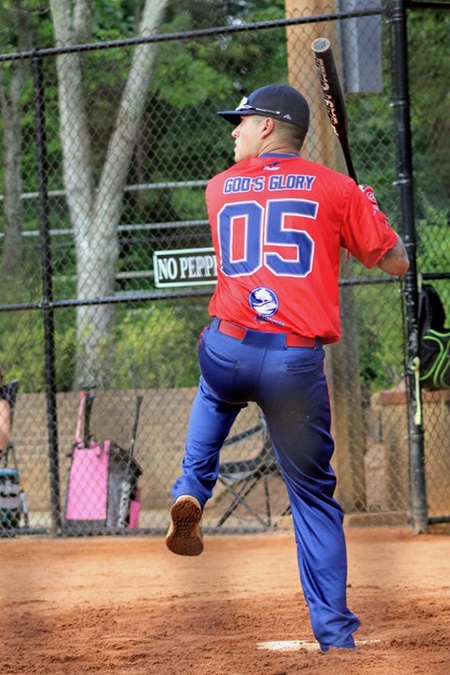 VMI police officer Zach Higgins prepares to swing a bat during a recreational softball game.