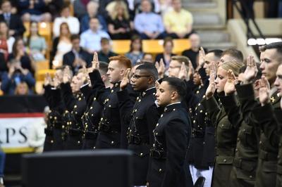 VMI cadets in Marine and Army ROTC raise their hands as they take their service oaths.