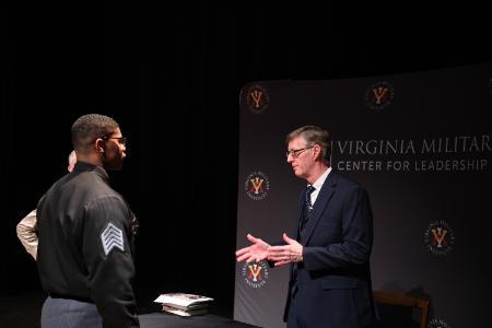 Robert Child talks with a cadet after his presentation in Gillis Theater.