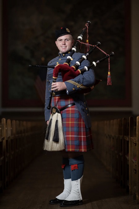 Dakota Birdsong ’24, a cadet at Virginia Military Institute, poses with his bagpipe and VMI Pipe Band uniform, which includes a tartan.