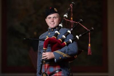 Dakota Birdsong ’24, a cadet at Virginia Military Institute, poses with his bagpipe and VMI Pipe Band uniform, which includes a tartan.