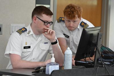 Caleb Fender ’25 and Cole Bowyer ’25 review their slide show before giving their capstone presentation.