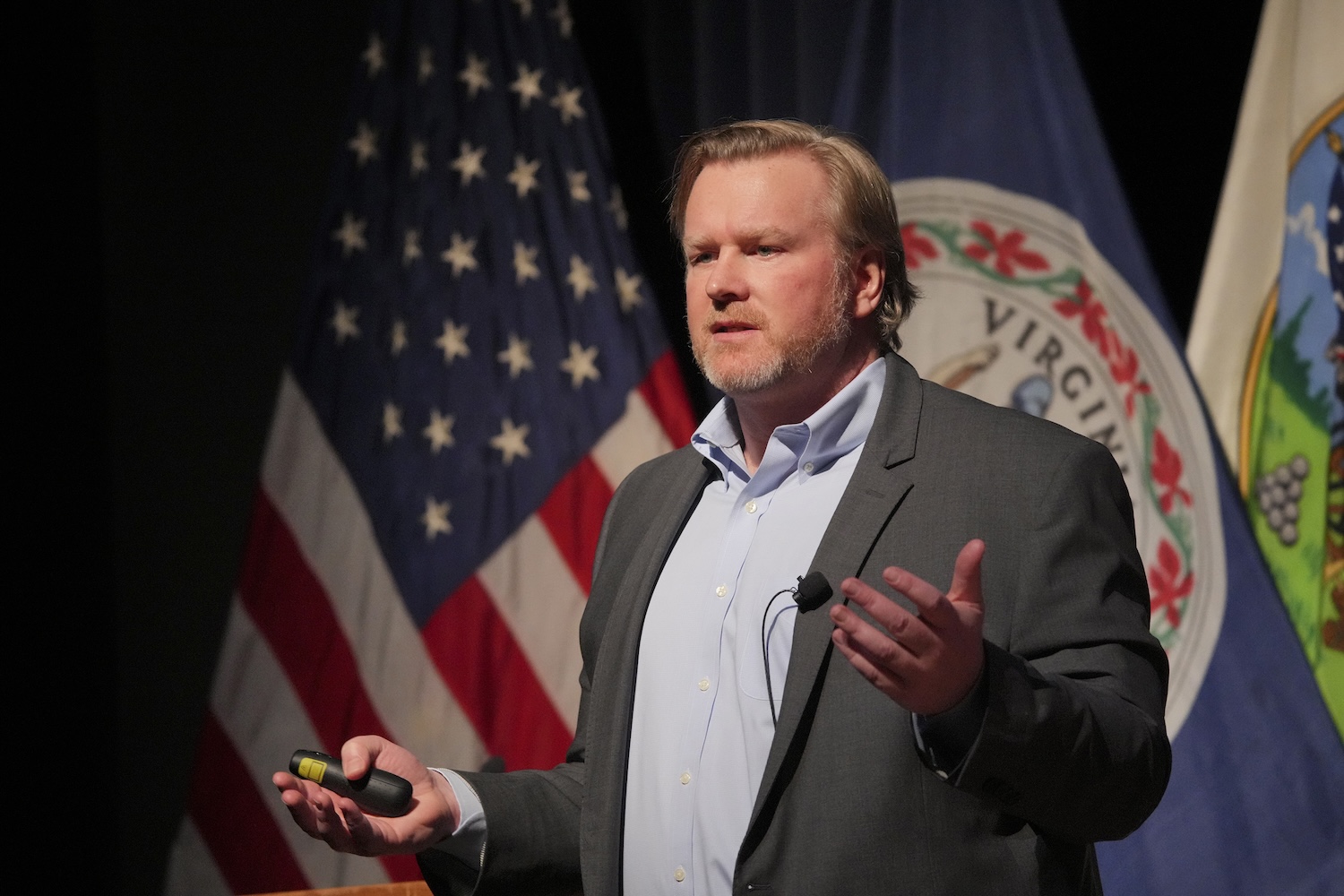 Ben Byboth discusses fusion power and the plant being built in Chesterfield County, to a large assembly in Gillis Theater.