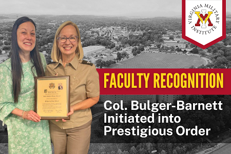 Dr. Sabrina Laroussi congratulates Col. Kathleen Bulger-Barnett as they hold a certificate.