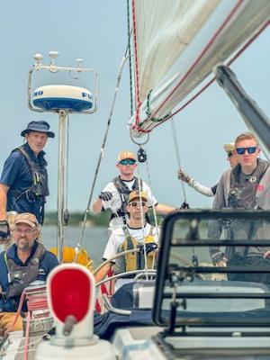 Adam Brinkley ’27 (right) stands watch with other crew members of the Warrior.