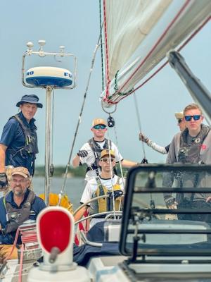 Adam Brinkley ’27 (right) stands watch with other crew members of the Warrior.
