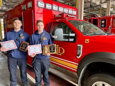 Mikhail Tulupov ’25 and Dylan Holback ’26 display their awards at the fire house in Lexington.