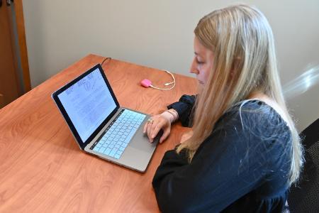 Anna Grace Adams ’26 reads a letter she found at the National Archives and Records Administration addressed to the U.S. Secretary of State, dated December 1920.