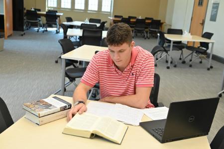 VMI student (cadet) studies Tolkien texts as part of his undergraduate research work in Preston Library.