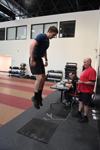 Col. Mike Krackow measures the jump height of Aidan Carman ’27 as Colton Shirk ’27 observes.