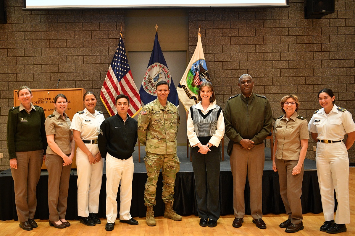 Cadet fellows, program leadership, and moderators pose with VMI's superintendent after April's debate.