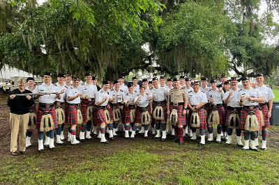 Members of VMI pipe band pose for a group photo in their kilts.