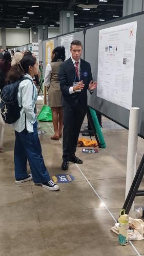 Charles McLaughlin ’26 discusses his research to an academic peer at the American Chemical Society’s fall conference at the Washington Convention Center in August