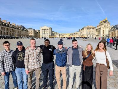 The gilding on the roof of Palace of Versailles gleams under a blue sky as cadets prepare to explore the grounds.