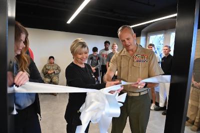 Glenda Dudley and Lt. Gen. David Furness ’87 cut the ribbon to open the new barber shop.