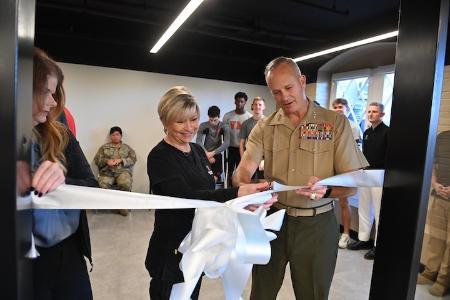 Glenda Dudley and Lt. Gen. David Furness ’87 cut the ribbon to open the new barber shop.