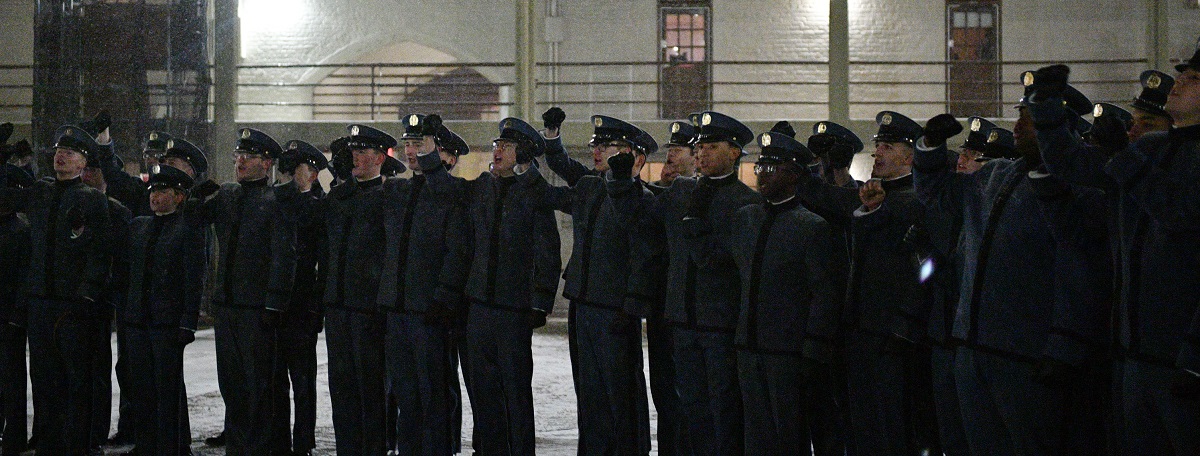 The new class of 2029 cheers with hands raised.
