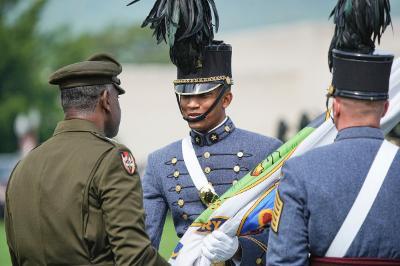 Devin Auzenne ’26 accepts the VMI flag from Maj. Gen Cedric T. Wins ’85, ceremoniously transferring leadership of the Corps to him. –VMI Photo by H. Lockwood McLaughlin.